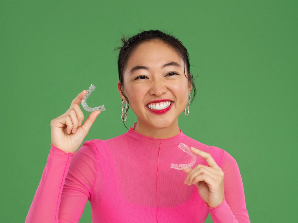 Woman holding clear aligners