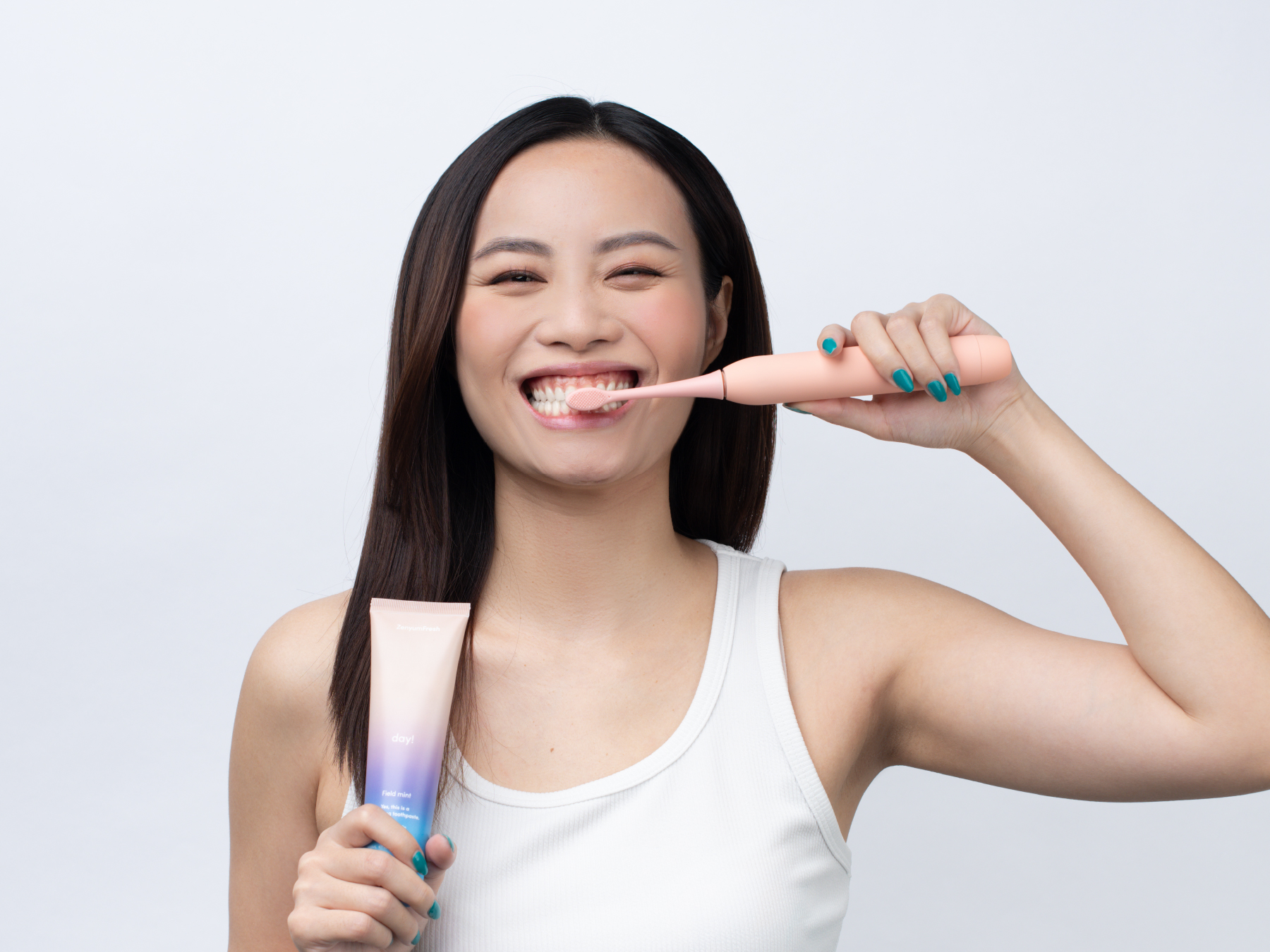 Girl brushing her teeth with ZenyumSonic Toothbrush