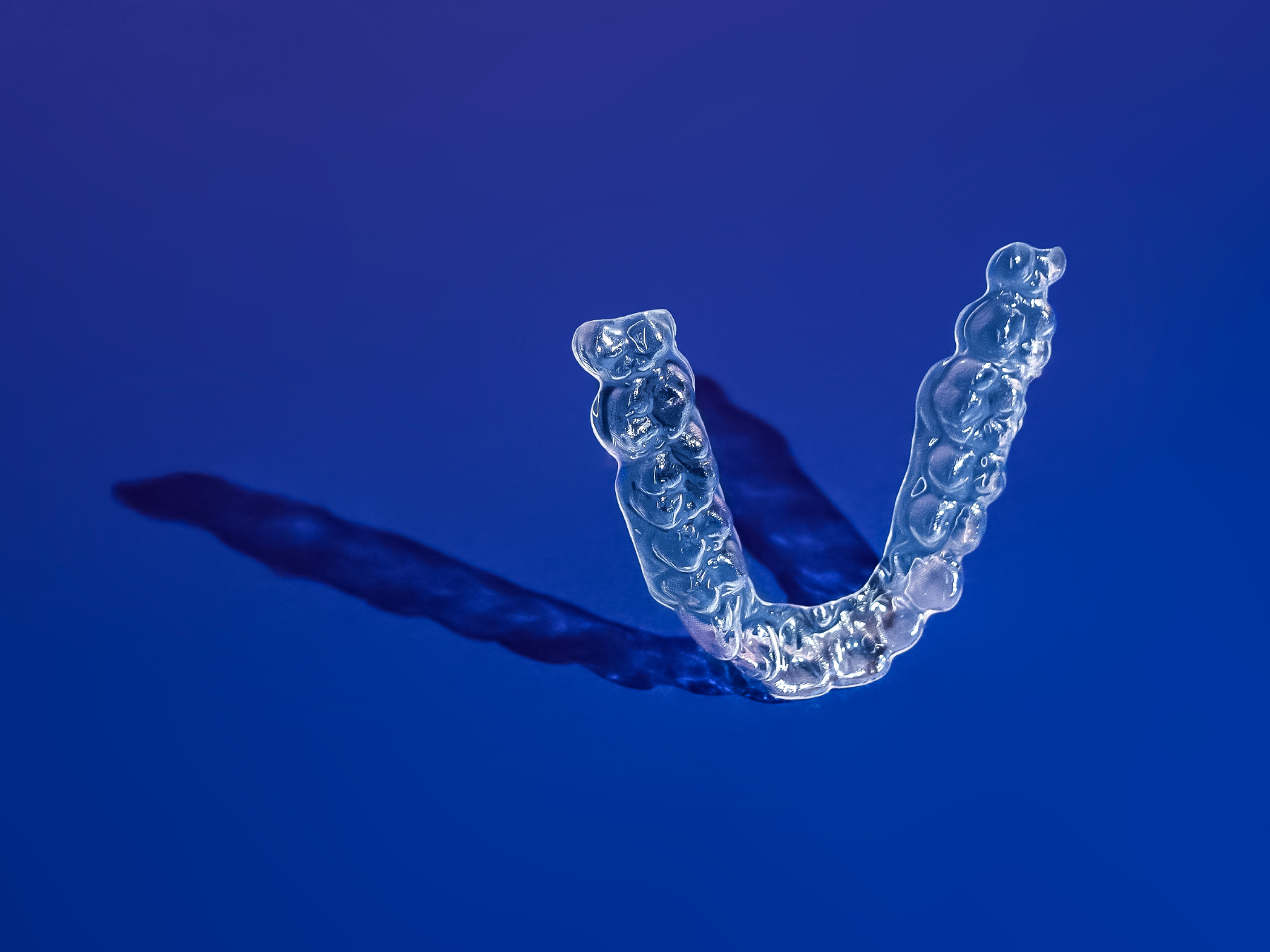 invisible braces with dark blue background
